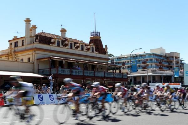 Riders speed past the famous Stag Hotel on East Terrace