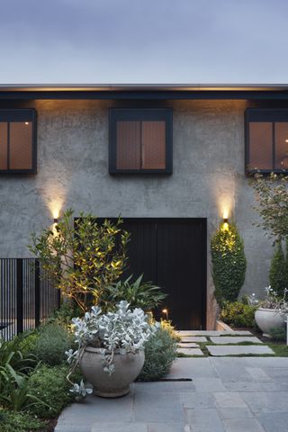 A front door with architectural lighting