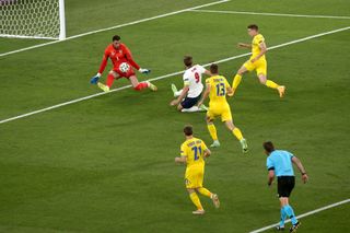 Harry Kane, centre, slides in to give England an early lead