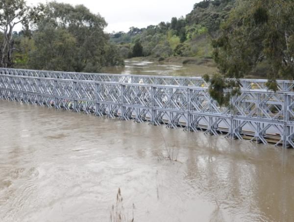 The water rose to within inches of flooding over the top of the bridge about three hours before the river was expected to peak.