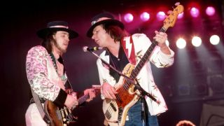 American musician and lead singer Stevie Ray Vaughan (1954-1990) of the group Stevie Ray Vaughan and Double Trouble, plays on stage with American bass guitarist Tommy Shannon during the Soul to Soul Tour on September 27, 1985 at Hill Auditorium in Ann Arbor, Michigan.