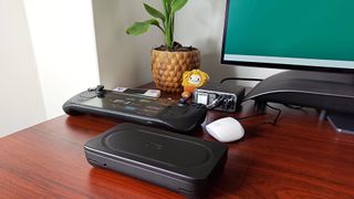 Acefast Desktop Powerstation Z4 sitting on desk with Steam Deck OLED, Ayaneo Flip DS, and Asus wireless earbuds connected