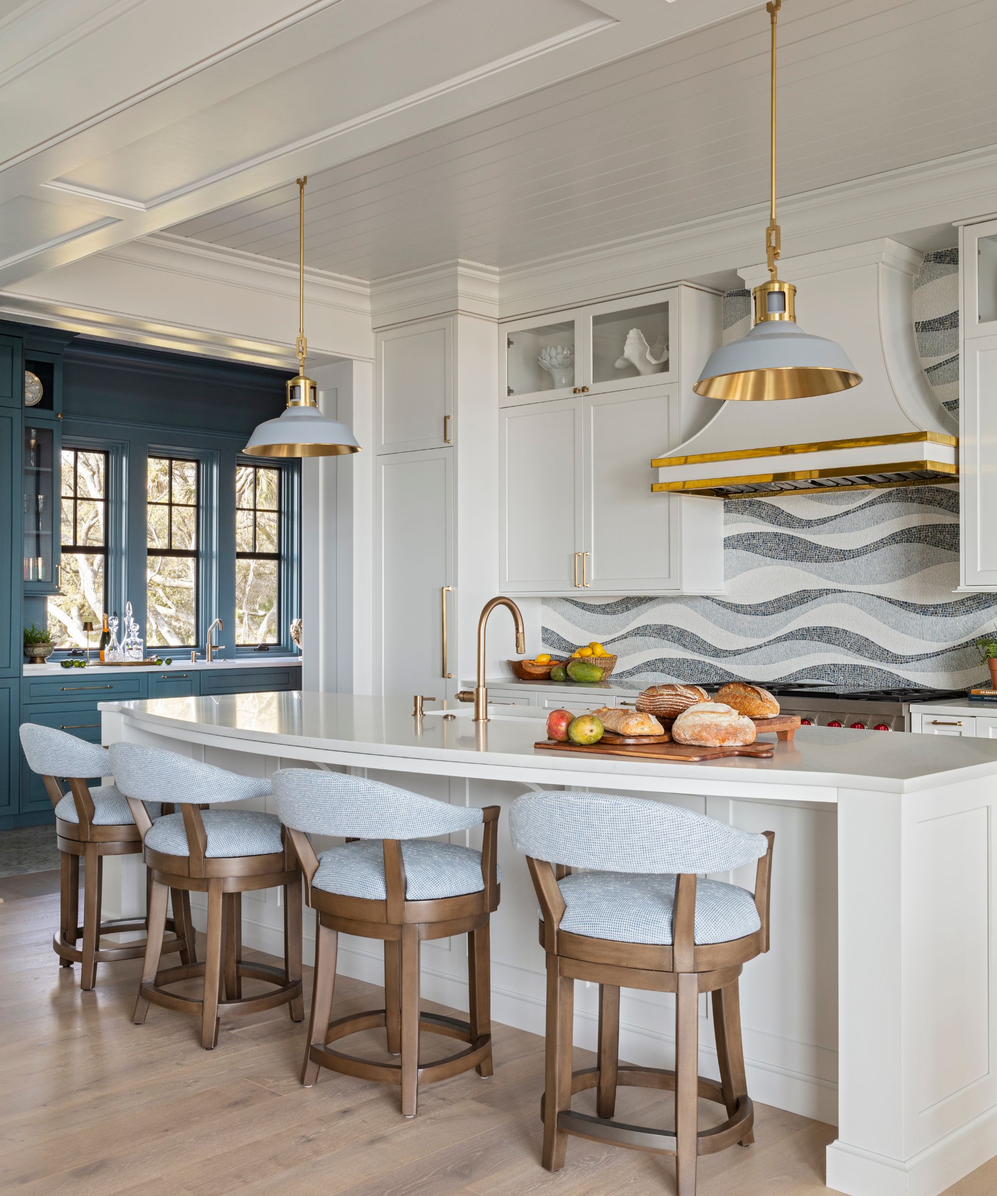 modern kitchen with white cabinets, walls and island with bar chairs