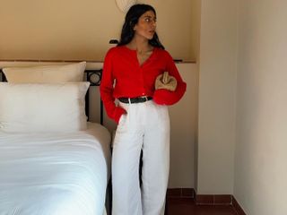 Monique Dale wears J.Crew white linen trousers, red top and sandals.
