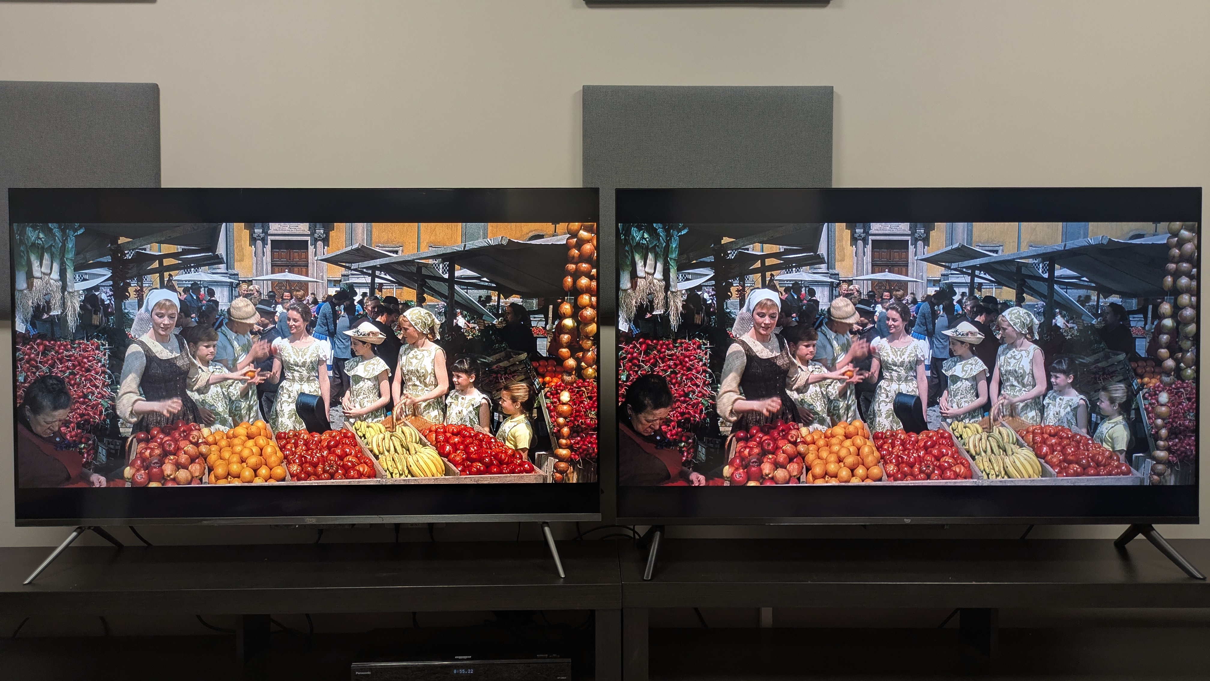 Amazon Ember QLED (left) and Amazon Ember 4-series (right) showing the market scene from The Sound of Music. Both TVs show decent color reproduction, but the QLEDs colors are punchier and brighter.