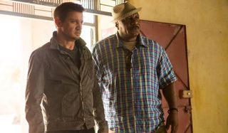 Jeremy Renner and Ving Rhames looking serious at the door in Mission: Impossible - Rogue Nation.