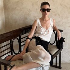 Andrea Ricci wearing a white dress. 