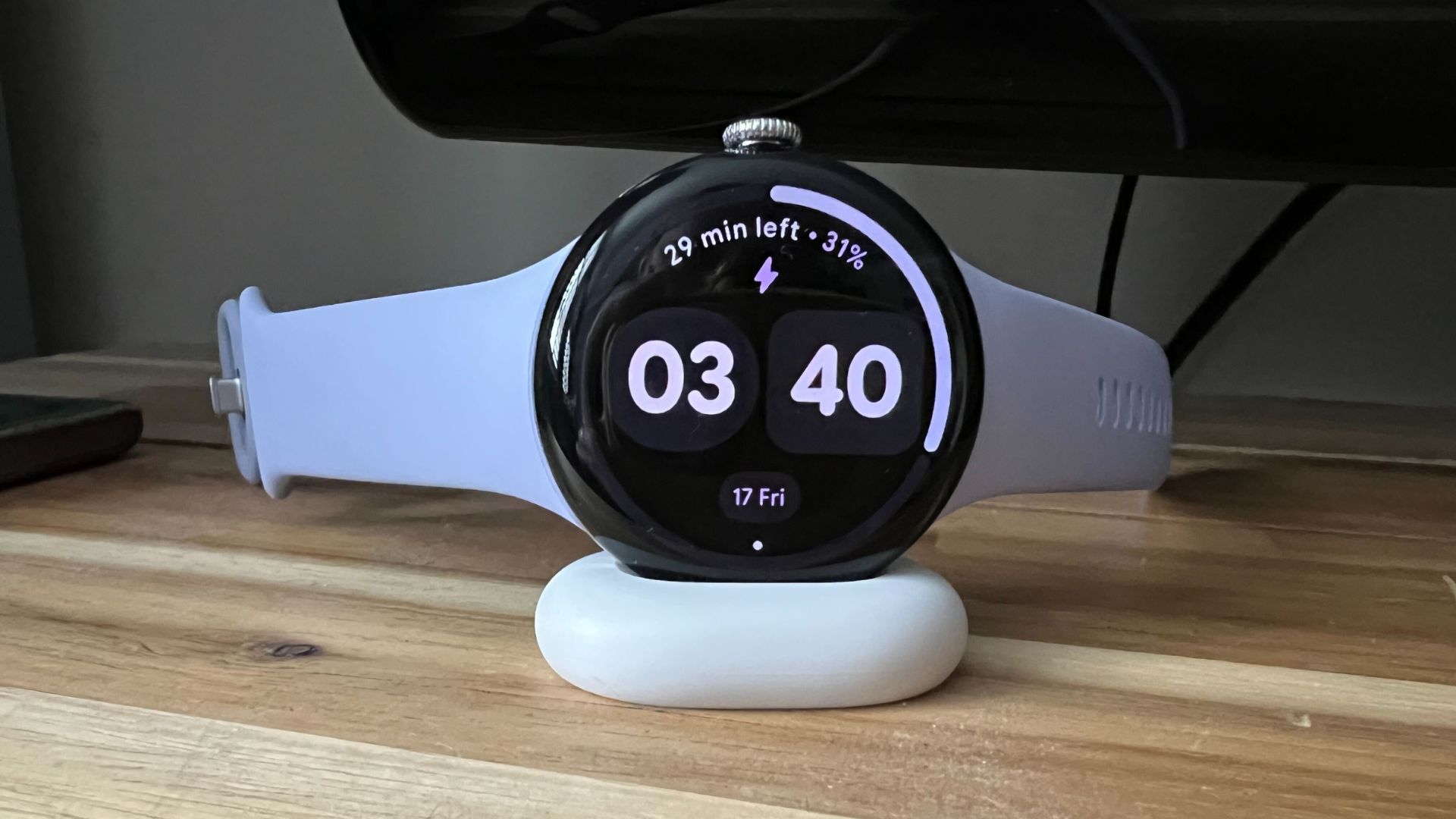 Grace Walsh&#039;s Google Pixel Watch 4 charging on mount on wooden counter