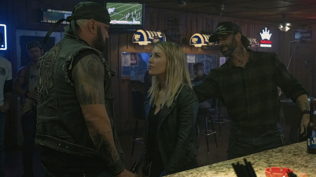 Emilia Harcourt squares up to two bikers in a bar in Peacemaker season 2
