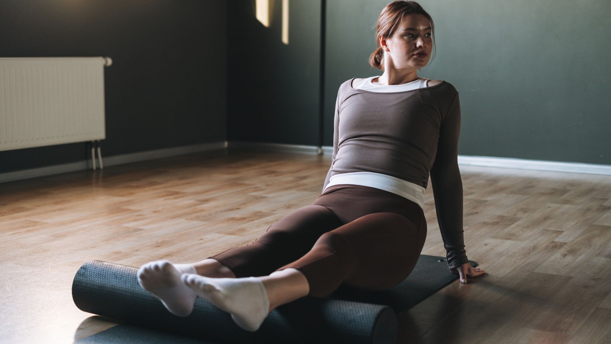 woman using a foam roller on her legs