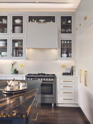 how to create more storage in a small kitchen with white cabinets and brass handles