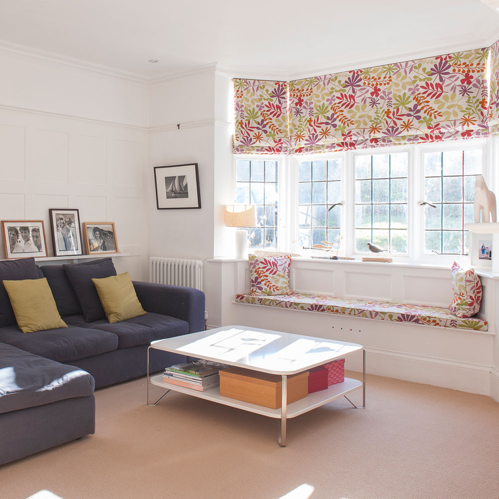 living room with window and frames on wall and couch