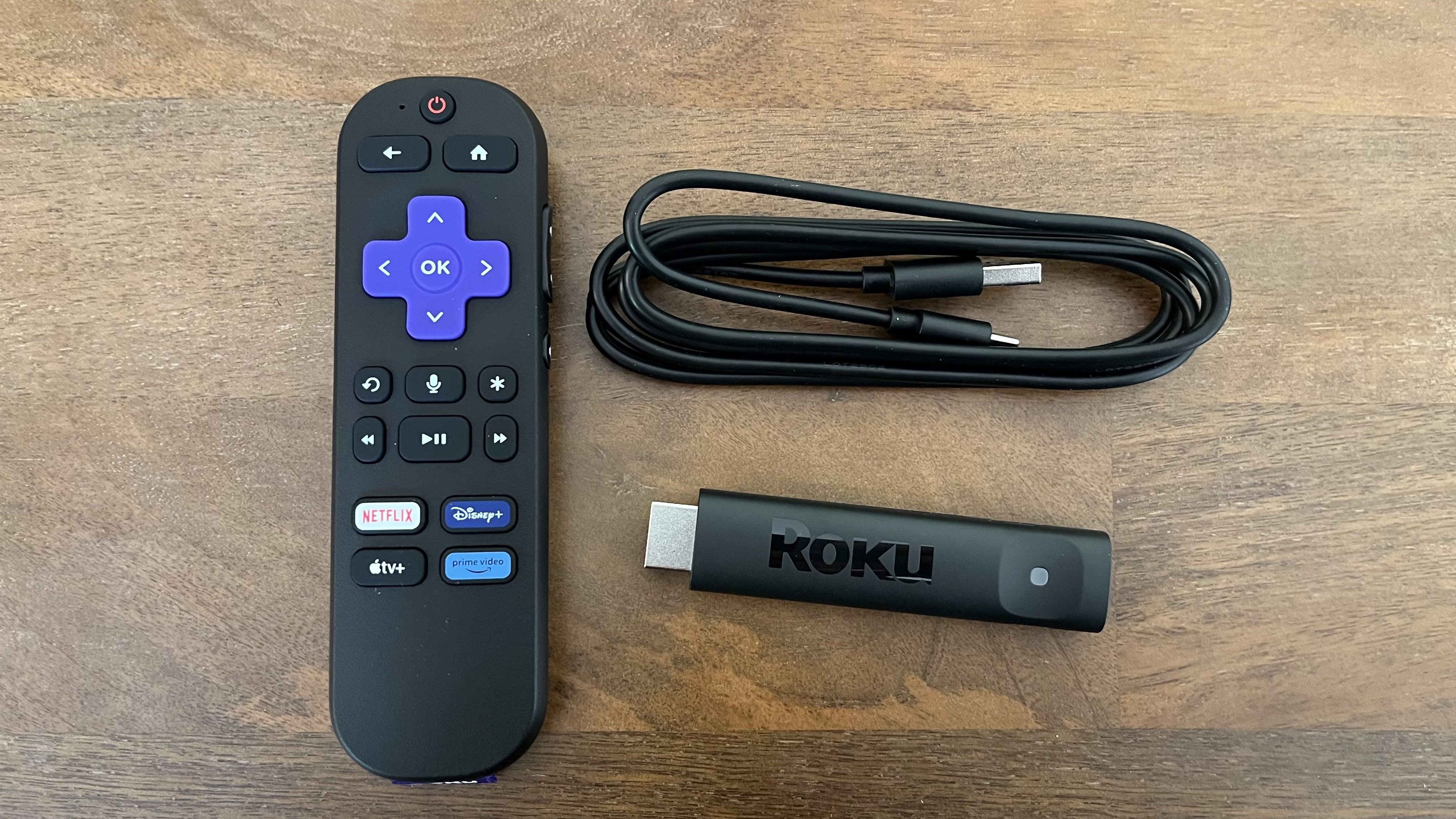 Roku Streaming Stick Plus on table with accessories