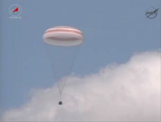 Russian Soyuz TMA-03M space capsule descends to Earth under its main parachute.