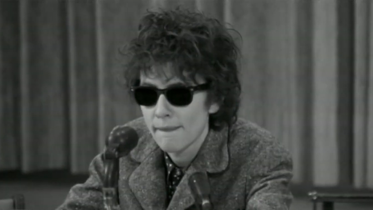 Cate Blanchett in black and white, where sunglasses and looking like Bob Dylan in I'm Not There