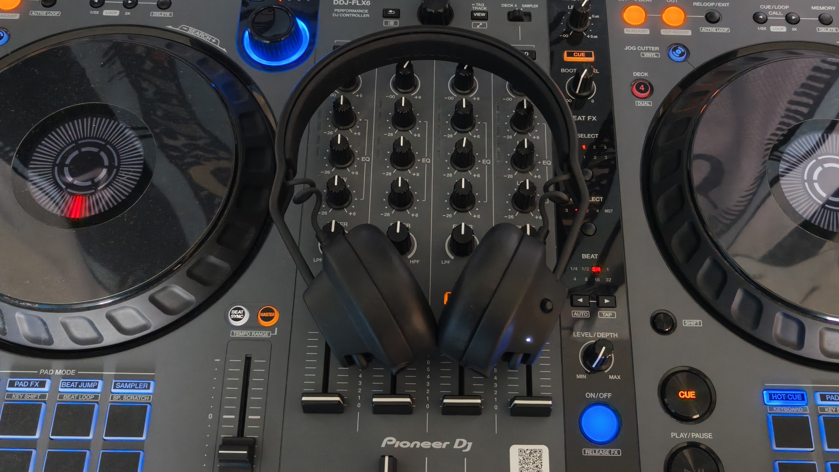 The AIAIAI TMA-2 DJ Wireless headphones resting on a Pioneer DJ controller