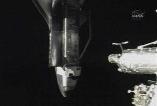 Shuttle Discovery Docks at Space Station