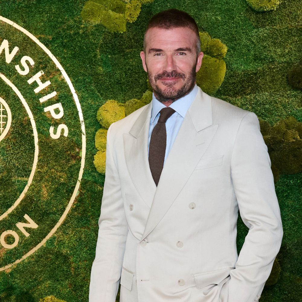 David Beckham arrives at Wimbledon wearing a cream suit