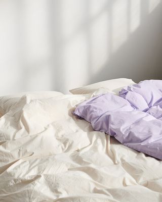Lavender and winter white organic cotton percale bedding, by Tekla
