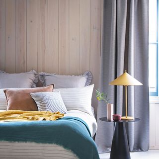 Bedroom with wooden wall paneling