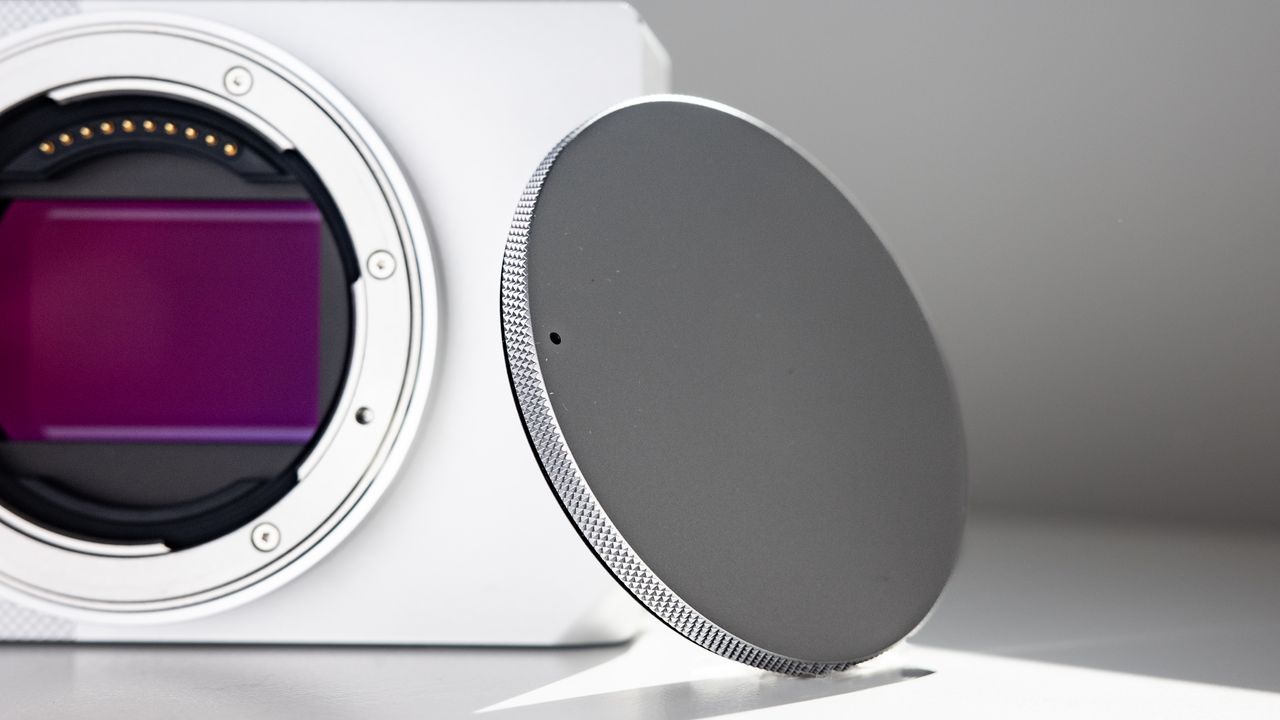 Sigma BF with its body cap, on a white surface in strong light, with defined shadows