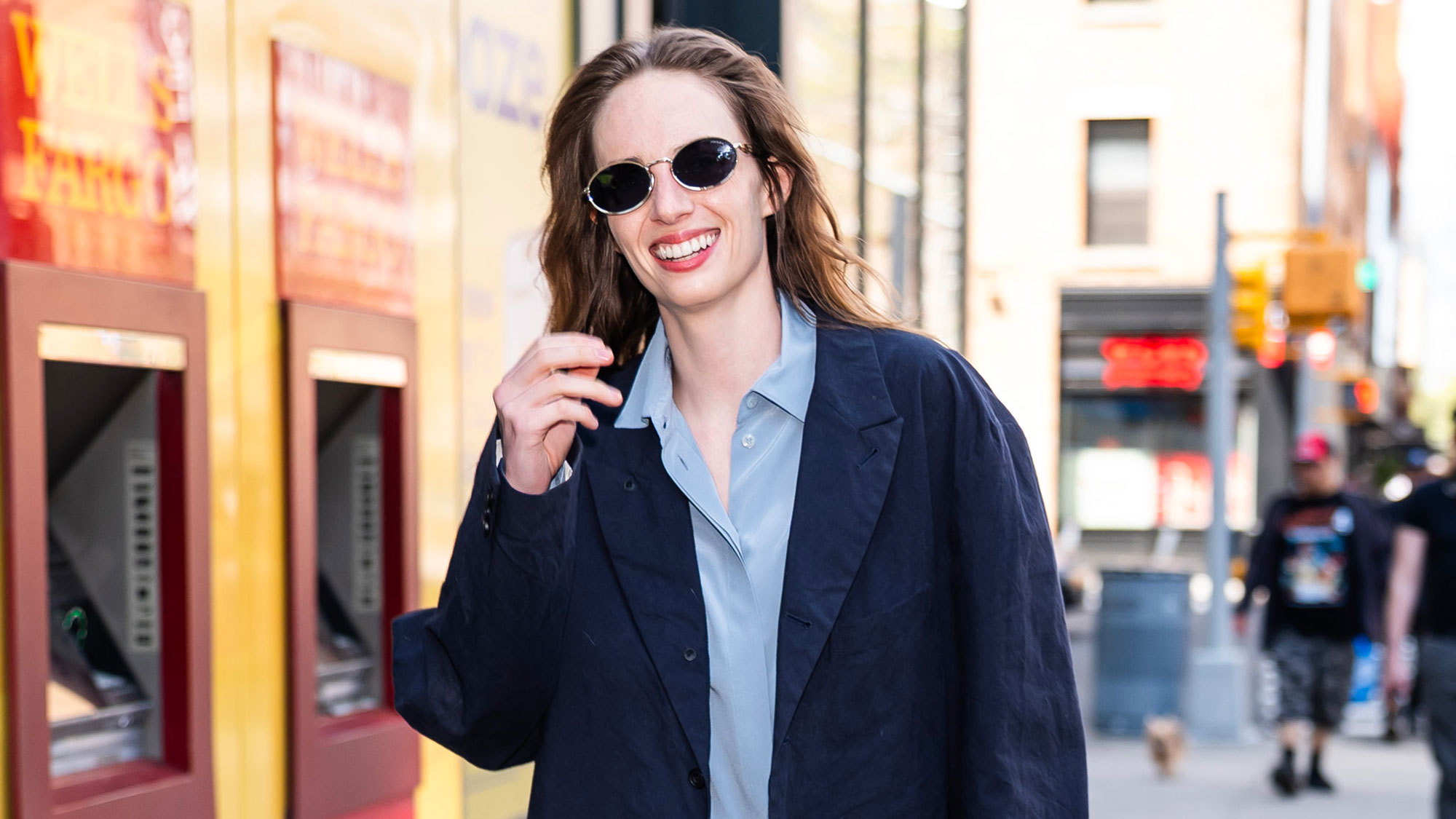 Maya Hawke wears a navy blazer