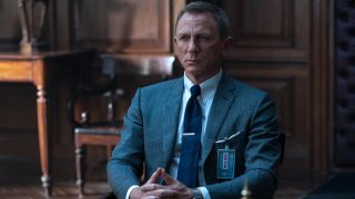 Daniel Craig sits patiently in M's office in No Time To Die.