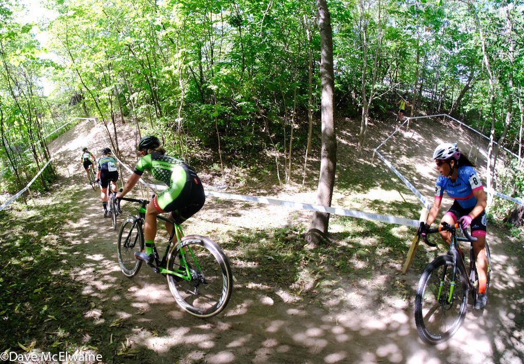 Kaitie Antonneau (Cannondale) and Courtenay McFadden riding in a chase group in a pretty wooded section of the course.