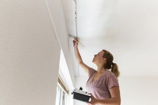 decorator cutting in when painting a ceiling
