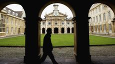 A student walks through Emmanuel College, University of Cambridge