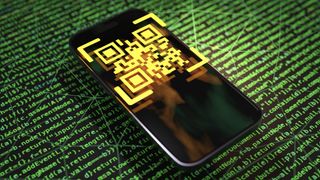 Yellow QR code floating above smartphone screen on a green code terminal background