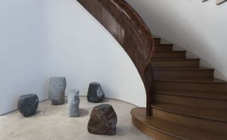 Max Lamb’s ‘Boulders’ collection of stools and chairs next to flight of wooden stairs
