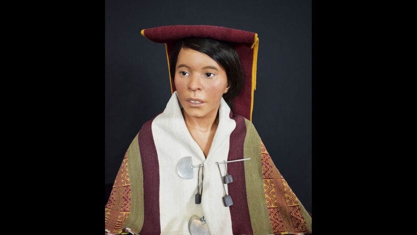 A model reconstruction shows a woman with short dark hair brushed under a red flat-top cap with a red and yellow dark veil behind it and a white and red cloak pinned to her body