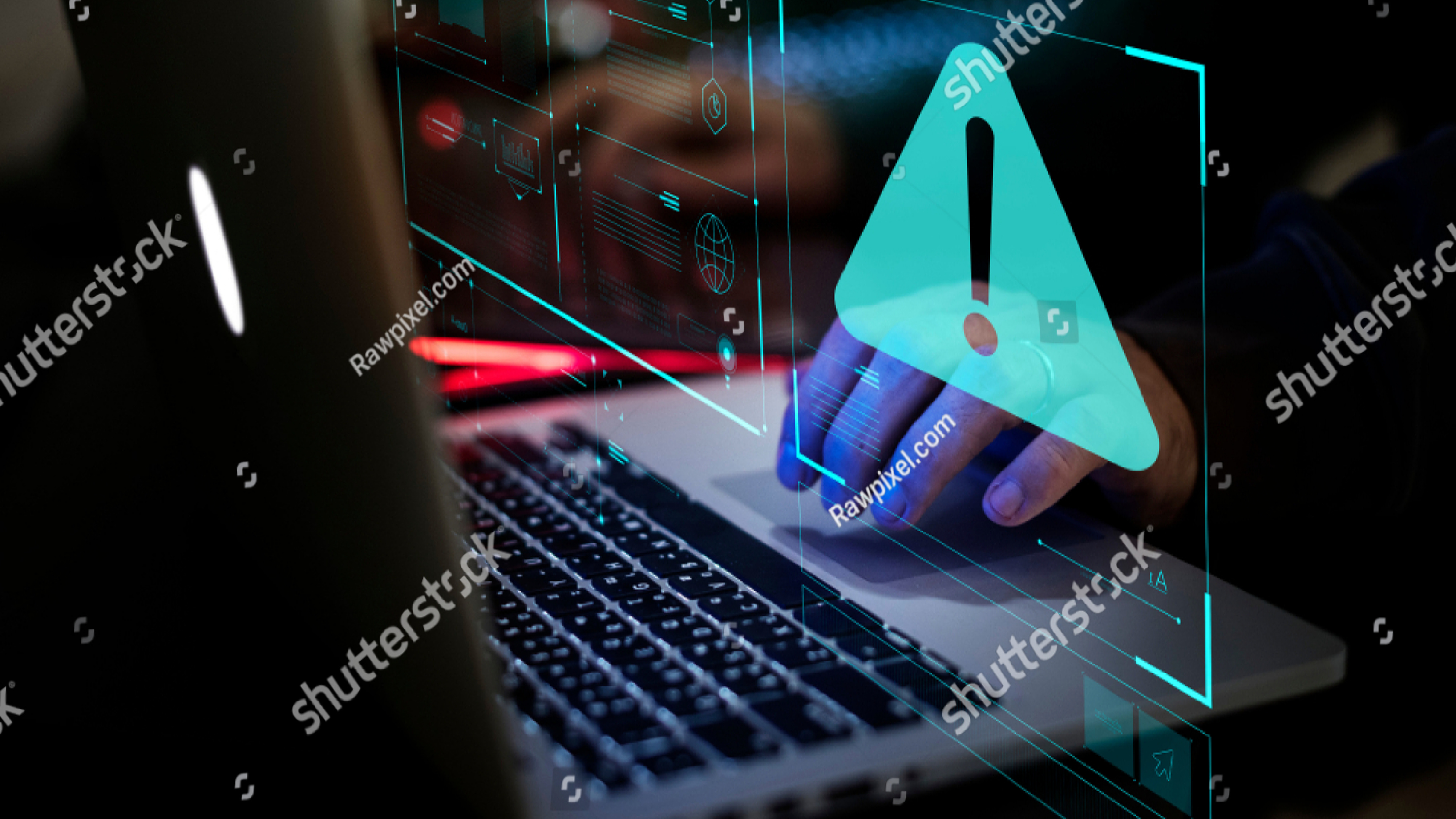 A computer being typed on representing a malware attack