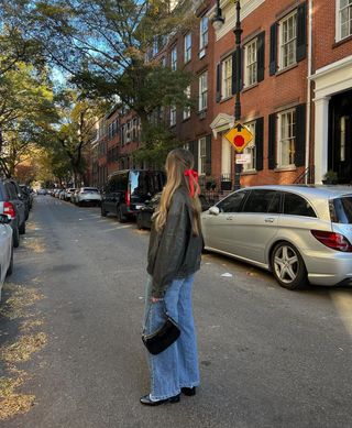 Flared jeans with flats and leather jacket