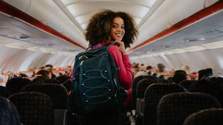 woman with backpack on plane