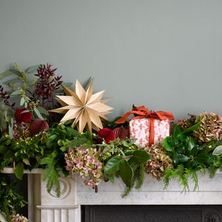 Paper Christmas decorations on a marble mantelpiece