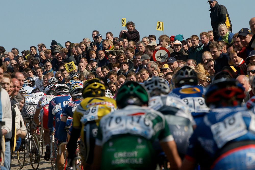 Crowds surround the riders.
