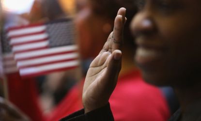 Immigrants in New York City raise their hands for the oath of allegiance to the United States to become citizens on March 22.