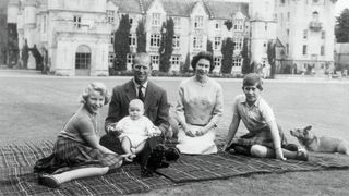 Queen Elizabeth II and Prince Philip, Duke of Edinburgh with their children, Prince Andrew (centre), Princess Anne (left) and Charles, Prince of Wales sitting on a picnic rug outside Balmoral Castle in Scotland, 8th September 1960