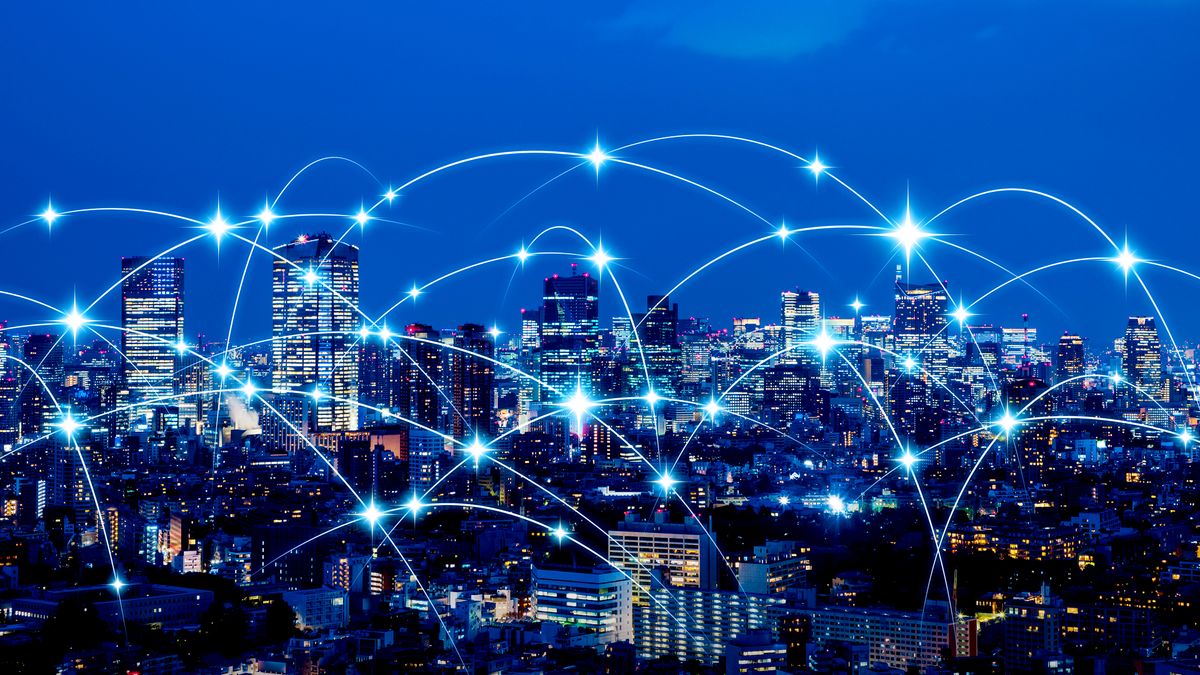 A city skyline connected by networks to represent IoT