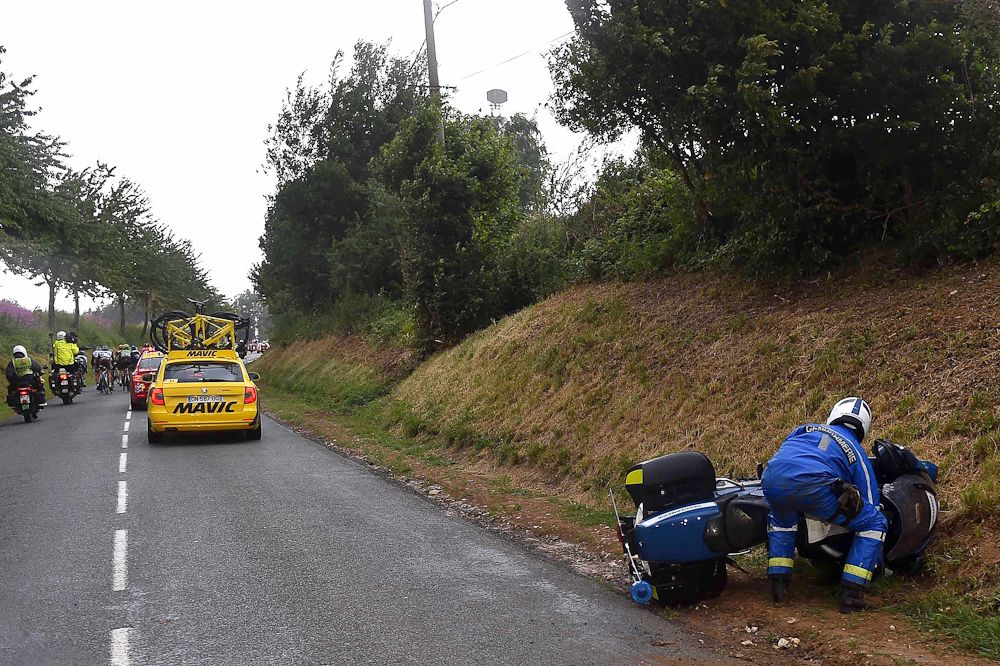 The cyclists weren't the only riders who had trouble with the wind and rain. A police moto lays on its side during stage 5.