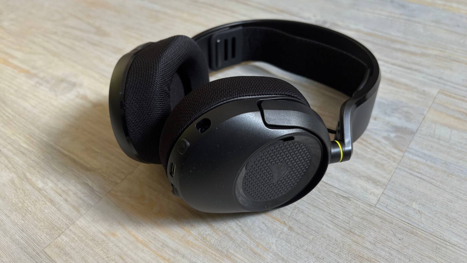 Corsair HS35 v3 ear cups showing subtle corsair branding against a white hardwood floor