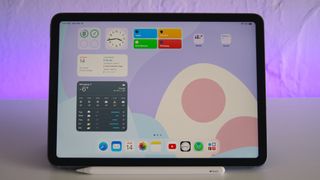 iPad Air 5 on a desk, showing widgets.