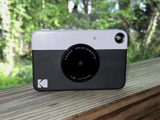 A photo of the Kodak Printomatic set against a green background