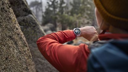 best Garmin watch: person looking at their Garmin watch outdoors