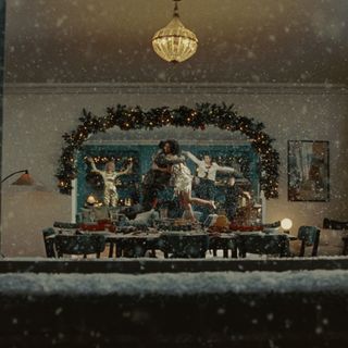 A still shot from the M&S Christmas ad 2024 with a view from the window with the snow falling like in a snow globe