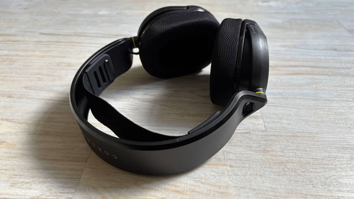 Corsair HS35 v3 on an angle, showing floating headband and ear cups against a white hardwood floor
