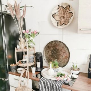 Boho kitchen with styled corner featuring natural materials accessories and aged metal tray