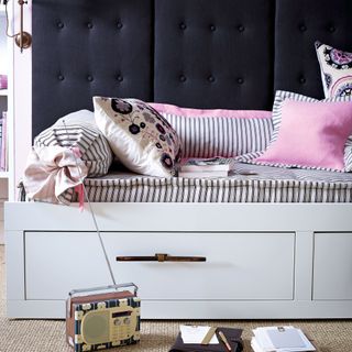 White daybed with striped cushion